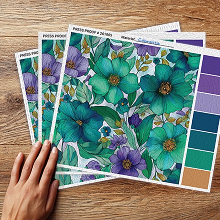 Physical press sample of custom wallpaper samples showing texture and color