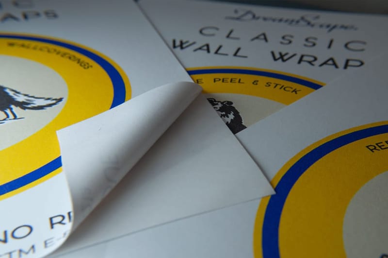 Closeup of peel and stick wallpaper with backing halfway peeled off