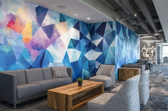 interior lobby with branded wall behind reception desk