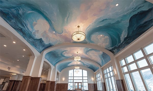 Ceiling with a printed ocean mural of sweeping, blue waves aquatic theme
