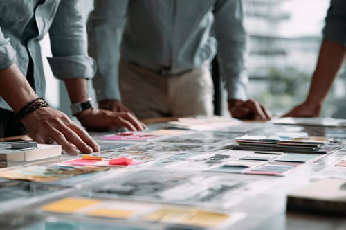 Photo of printing executives collaborating on a wallpaper project