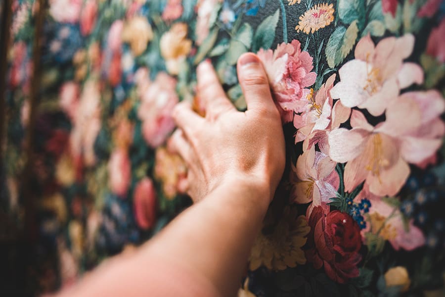 hand touching a wallpaper texture