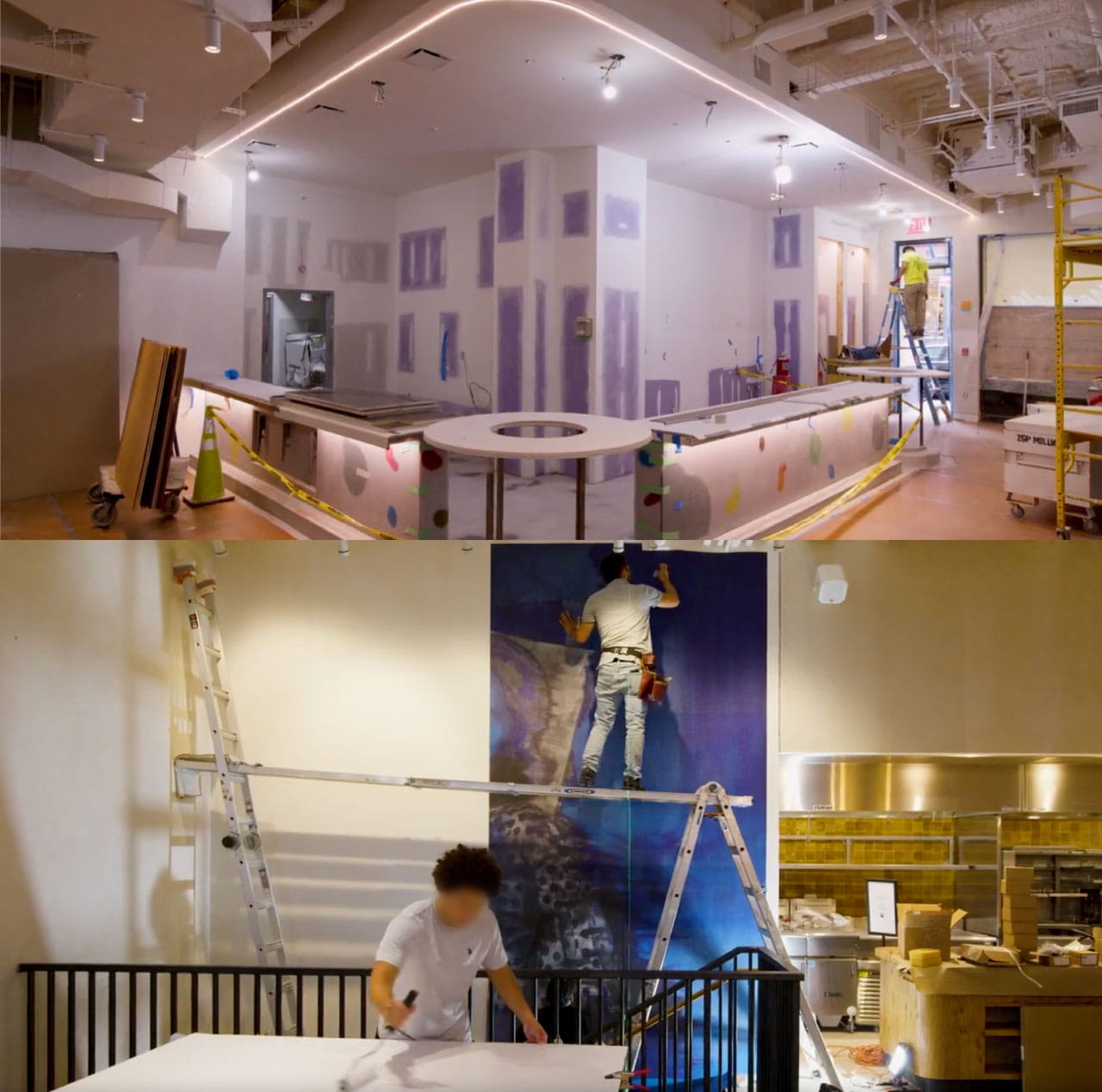 The printed canvas panels going up at Manuela before opening: the dining room still under fit-out, a panel being hung from a ladder, and a second installer working a roll at the stair rail